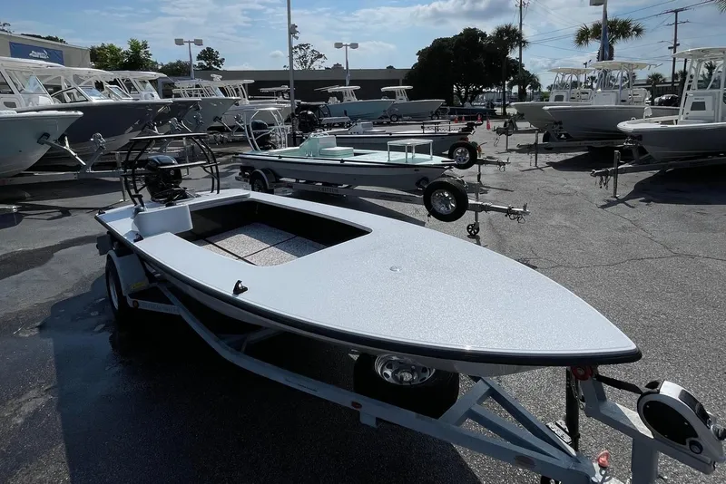 Slide: The Image of 2025 Chittum Skiffs Challenger 18 on trailer, parked among other boats. - 2