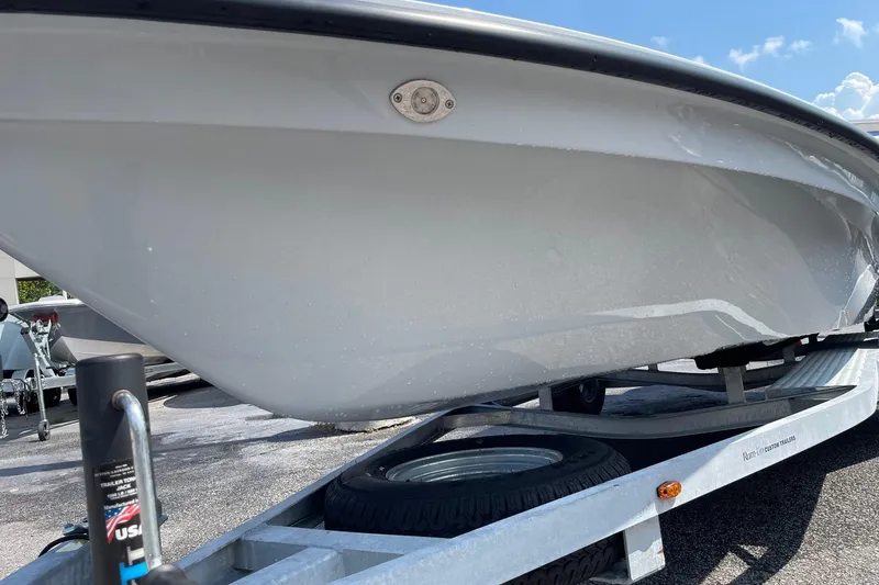 Slide: The Image of 2025 Chittum Skiffs Challenger 18 boat, sleek design, parked on a trailer. - 4