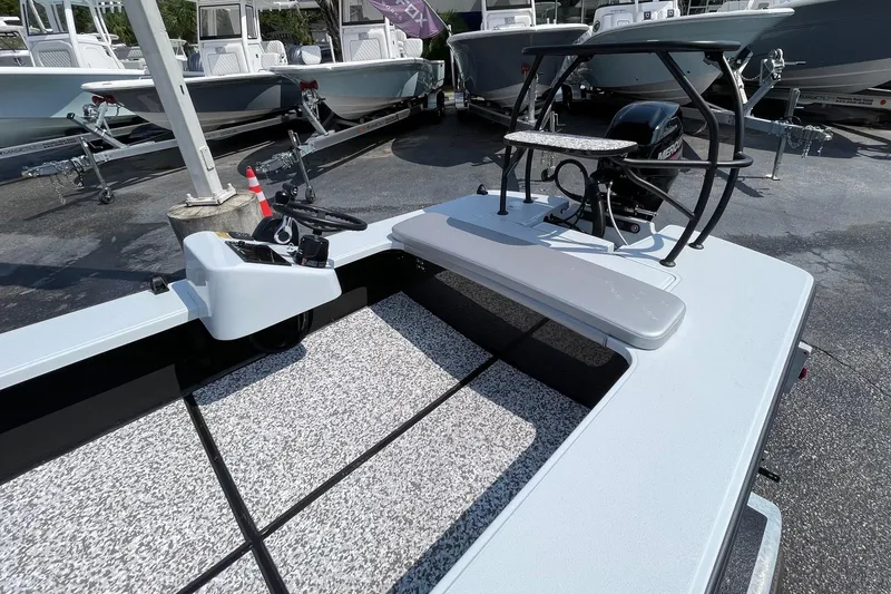 Slide: The Image of 2025 Chittum Skiffs Challenger 18 with Mercury 40 engine, parked outdoors. - 6