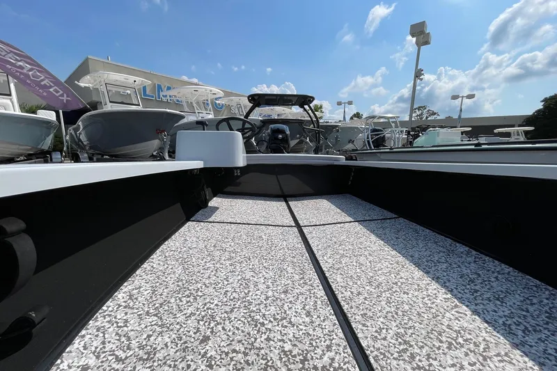 Slide: The Image of 2025 Chittum Skiffs Challenger 18 interior with textured flooring and storage compartment. - 9