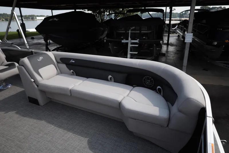 Slide: The Image of Luxurious seating on 2026 Barletta ARIA 22UC pontoon boat, docked with scenic lake view. - 10