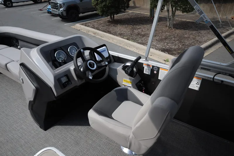 Slide: The Image of 2026 Barletta ARIA 22UC boat interior with steering console and seating. - 12