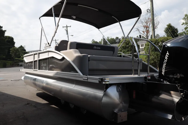 Slide: The Image of 2026 Barletta ARIA 22UC pontoon boat with Mercury engine, docked outdoors. - 4