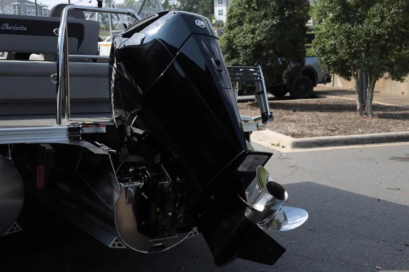Slide: The Image of 2026 Barletta ARIA 22UC boat with powerful outboard motor in a parking area. - 6