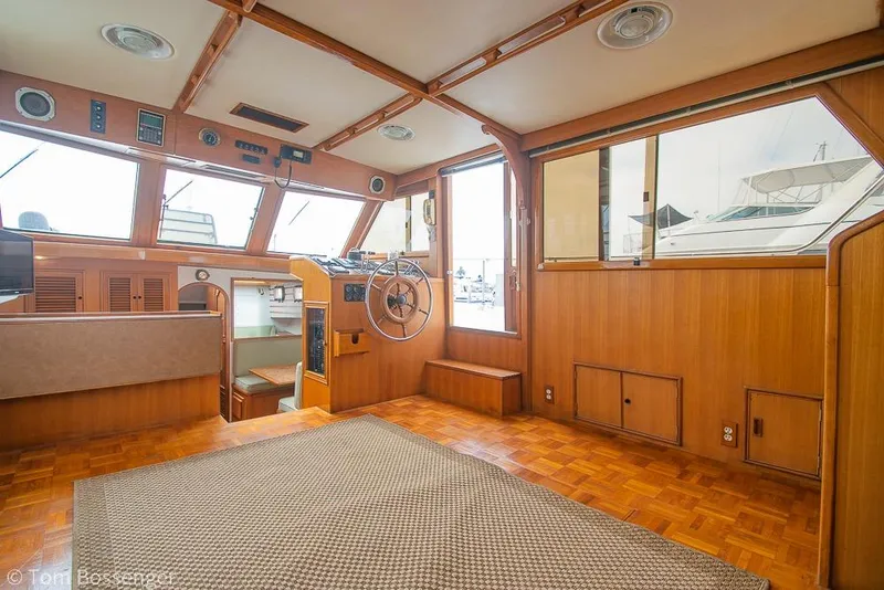 Slide: The Image of Interior of 1986 Ponderosa 47 yacht with wooden paneling and steering wheel. - 10