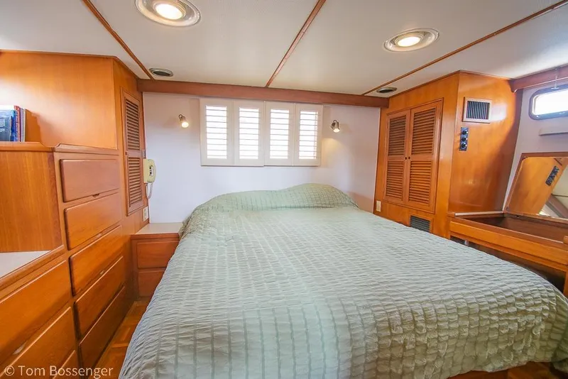 Slide: The Image of Cozy bedroom in 1986 Ponderosa 47 yacht with wood paneling and soft lighting. - 21