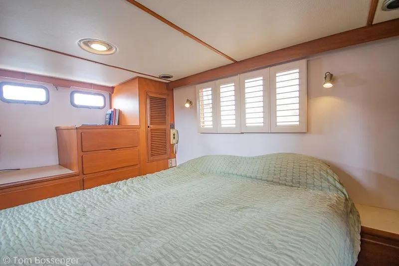 Slide: The Image of Cozy bedroom interior on 1986 Ponderosa 47 yacht with wood accents and soft lighting. - 22