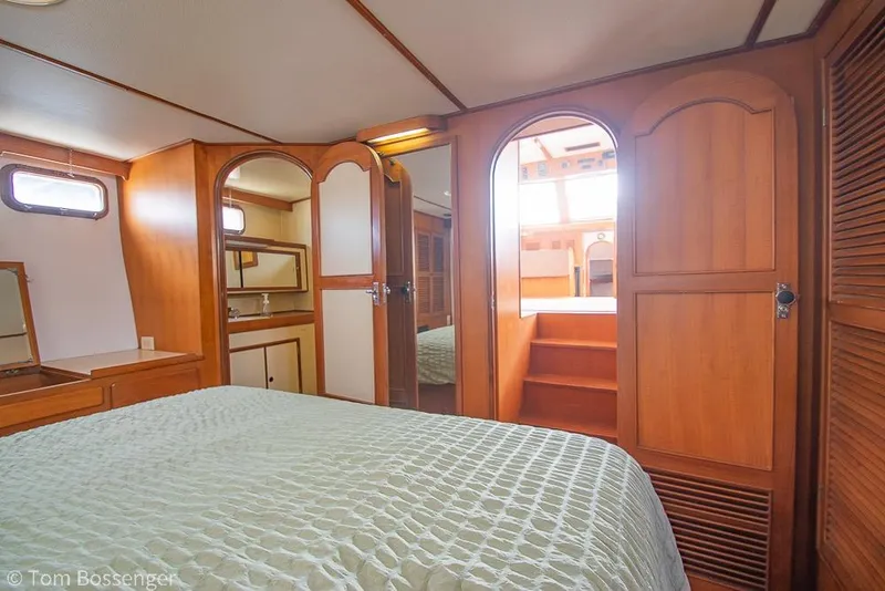 Slide: The Image of Cozy cabin interior of 1986 Ponderosa 47 yacht with wooden finish and bed. - 23