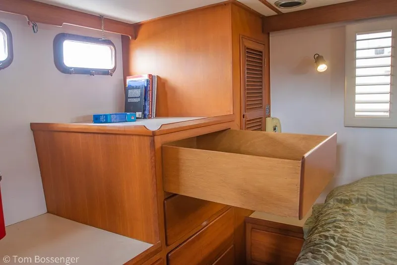Slide: The Image of Interior of 1986 Ponderosa 47 yacht with wooden cabinetry and open drawer. - 24