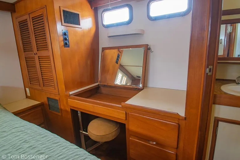 Slide: The Image of Wooden vanity area inside 1986 Ponderosa 47 yacht, featuring mirror and storage drawers. - 25