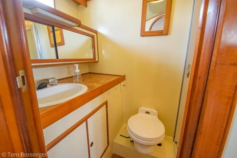 Slide: The Image of Compact bathroom in 1986 Ponderosa 47 yacht with wooden accents and modern fixtures. - 26