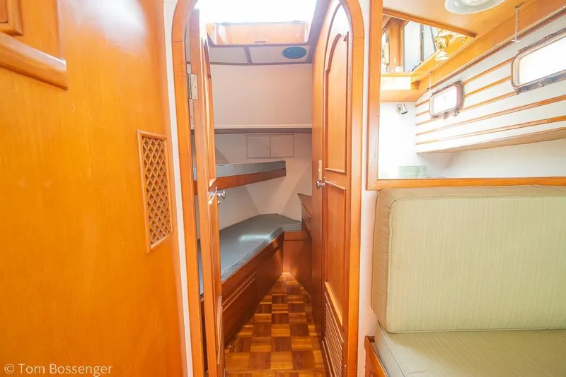 Slide: The Image of Interior of 1986 Ponderosa 47 yacht with wooden finish and cozy seating area. - 29