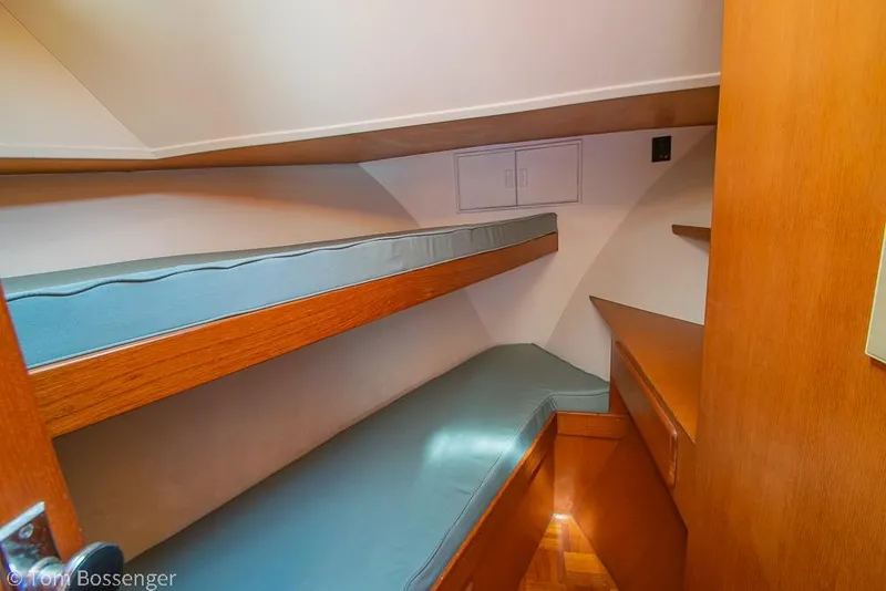 Slide: The Image of Interior of 1986 Ponderosa 47 yacht with wooden bunk beds and storage. - 30
