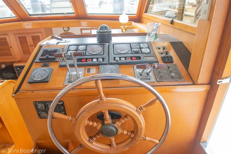 Slide: The Image of Wooden helm of 1986 Ponderosa 47 boat with navigation controls and gauges. - 32