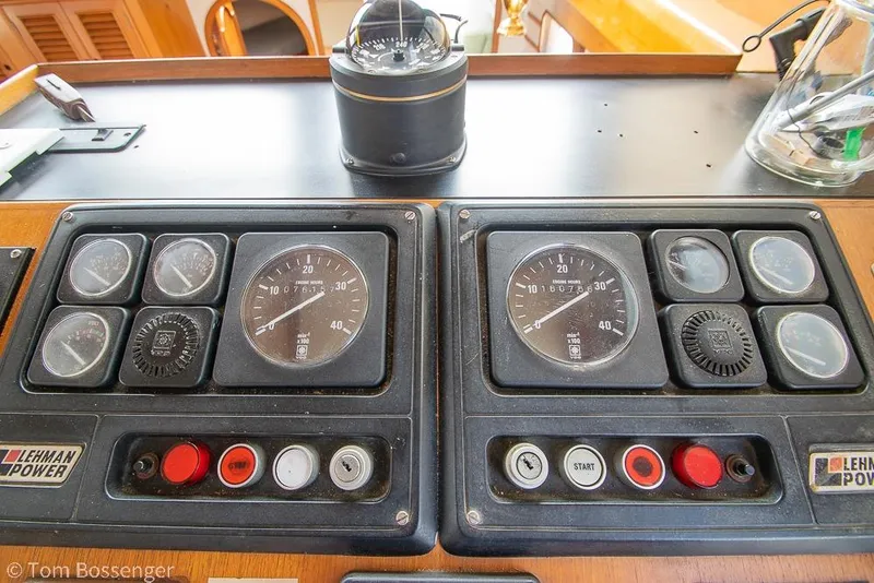 Slide: The Image of Control panel of a 1986 Ponderosa 47 boat with gauges and compass. - 35