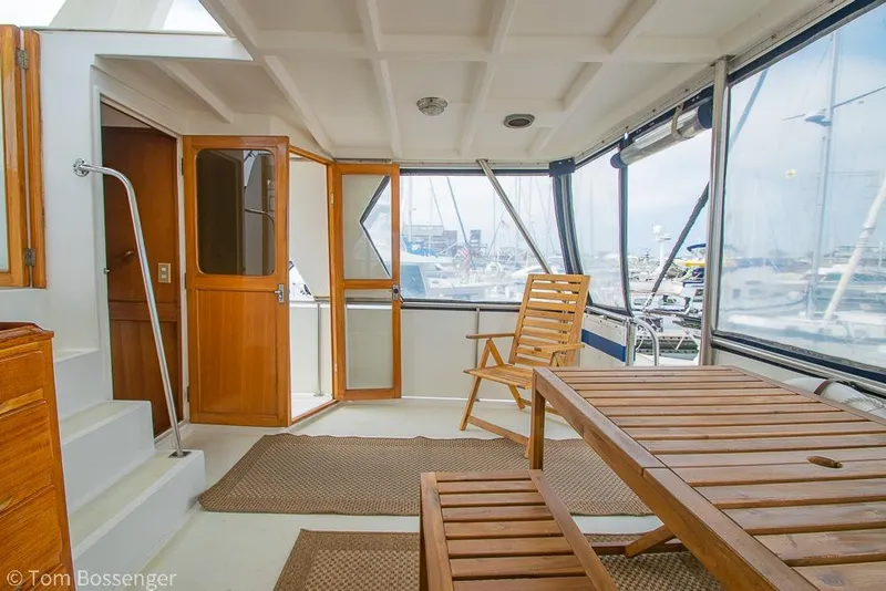 Slide: The Image of Interior of 1986 Ponderosa 47 yacht with wooden furniture and marina view. - 38