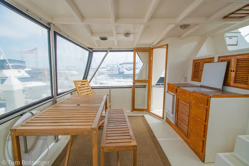 Slide: The Image of Interior of 1986 Ponderosa 47 yacht with wooden furniture and marina view. - 39