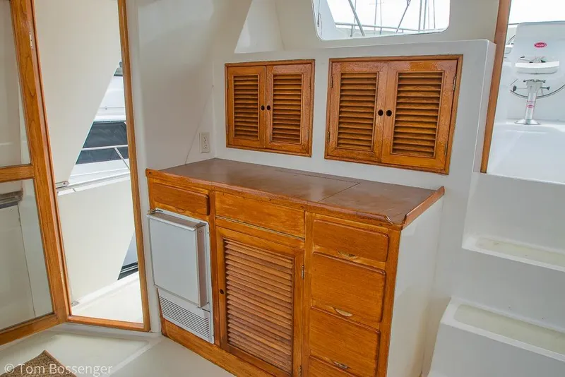 Slide: The Image of Interior of 1986 Ponderosa 47 yacht with wooden cabinets and compact fridge. - 40