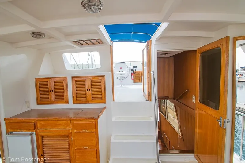 Slide: The Image of Interior of 1986 Ponderosa 47 yacht with wooden cabinets and stairs to upper deck. - 43