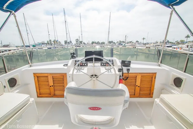 Slide: The Image of Helm of 1986 Ponderosa 47 yacht with marina view and nautical equipment. - 48