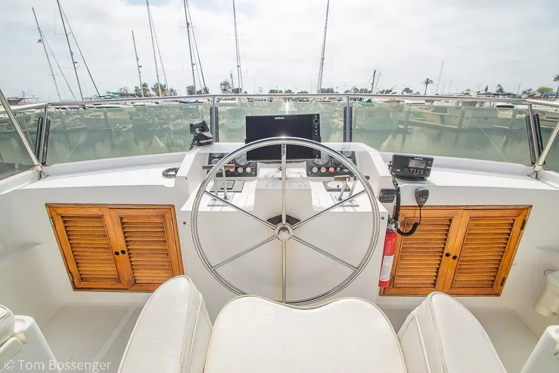 Slide: The Image of Helm of 1986 Ponderosa 47 yacht with steering wheel and control panel. - 49