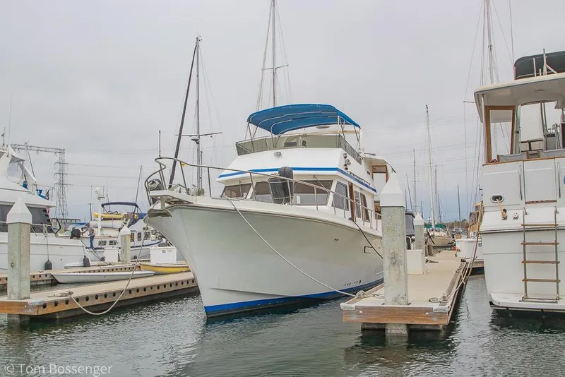 Slide: The Image of 1986 Ponderosa 47 yacht docked at marina, surrounded by other boats. - 5