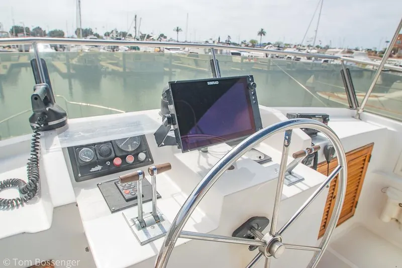 Slide: The Image of Helm of 1986 Ponderosa 47 yacht with steering wheel and navigation equipment. - 51