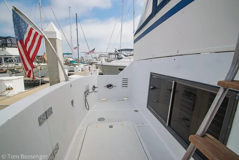 Slide: The Image of 1986 Ponderosa 47 yacht deck with American flag at marina. - 57
