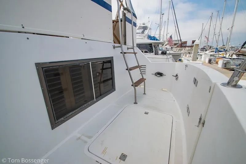 Slide: The Image of 1986 Ponderosa 47 yacht deck with ladder and marina view. - 58