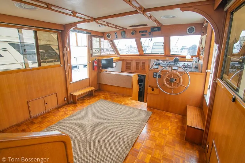 Slide: The Image of Interior of 1986 Ponderosa 47 boat with wooden helm and parquet flooring. - 6