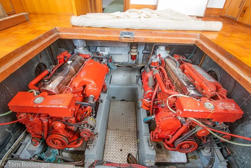 Slide: The Image of Engine room of a 1986 Ponderosa 47 boat with dual red engines. - 67