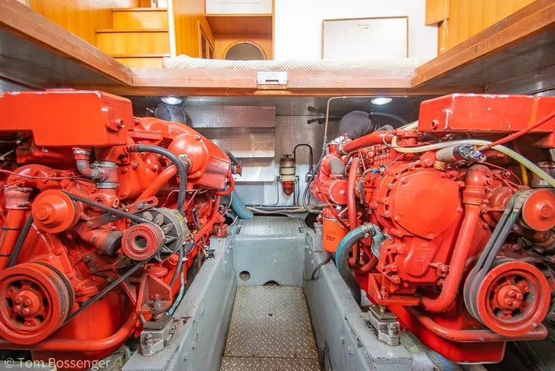 Slide: The Image of Engine room of a 1986 Ponderosa 47 yacht with dual red engines. - 68