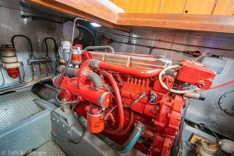 Slide: The Image of Red engine inside a 1986 Ponderosa 47 boat, detailed mechanical components visible. - 69