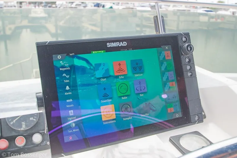Slide: The Image of Simrad navigation system on 1986 Ponderosa 47 boat, displaying various marine functions. - 77
