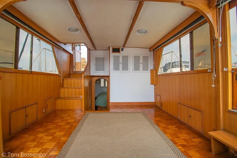Slide: The Image of Interior of 1986 Ponderosa 47 yacht with wooden paneling and carpeted floor. - 8