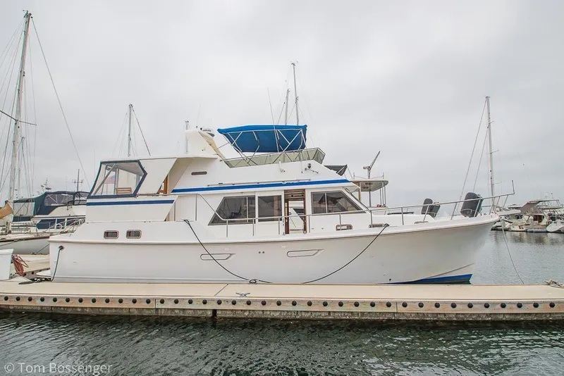 Slide: The Image of 1986 Ponderosa 47 yacht docked at marina on a cloudy day. - 80