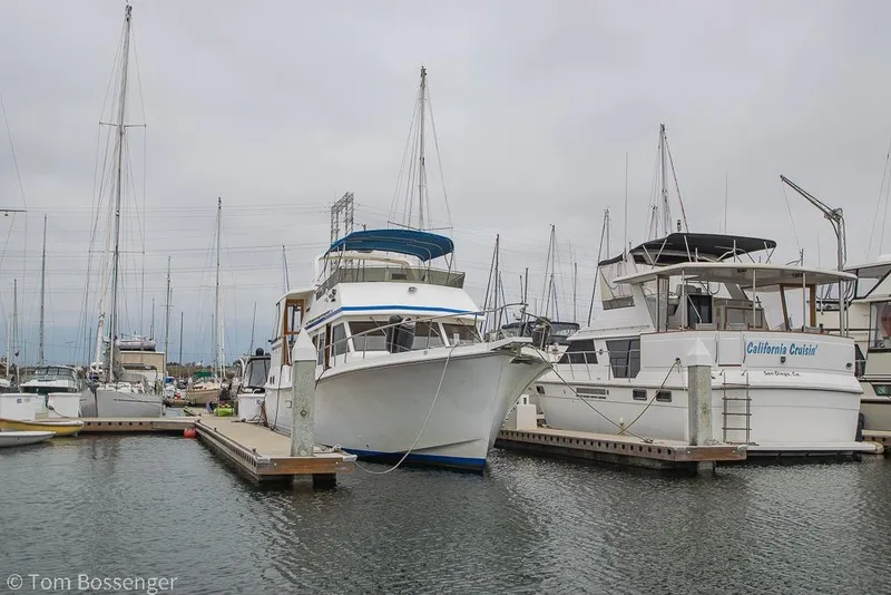 Slide: The Image of Boats docked at a marina, featuring a 1986 Ponderosa 47 yacht. - 83