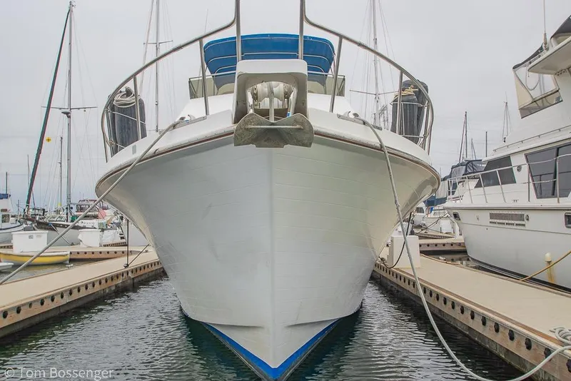 Slide: The Image of Front view of a 1986 Ponderosa 47 yacht docked at a marina. - 88