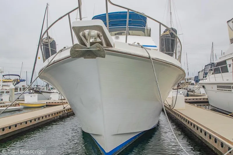 Slide: The Image of 1986 Ponderosa 47 yacht docked at marina, front view. - 89