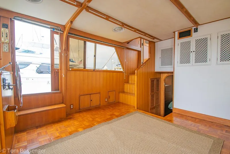 Slide: The Image of Interior of 1986 Ponderosa 47 yacht with wooden paneling and large windows. - 9