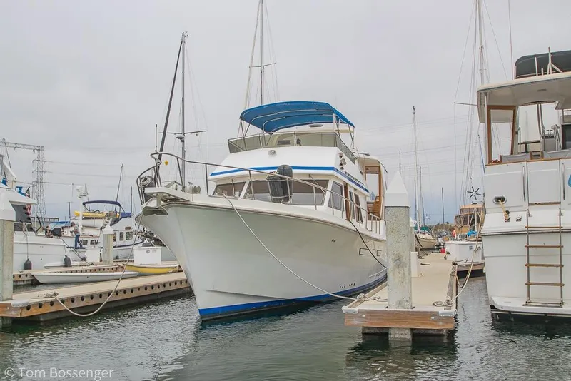 Slide: The Image of 1986 Ponderosa 47 yacht docked at marina, surrounded by other boats. - 91