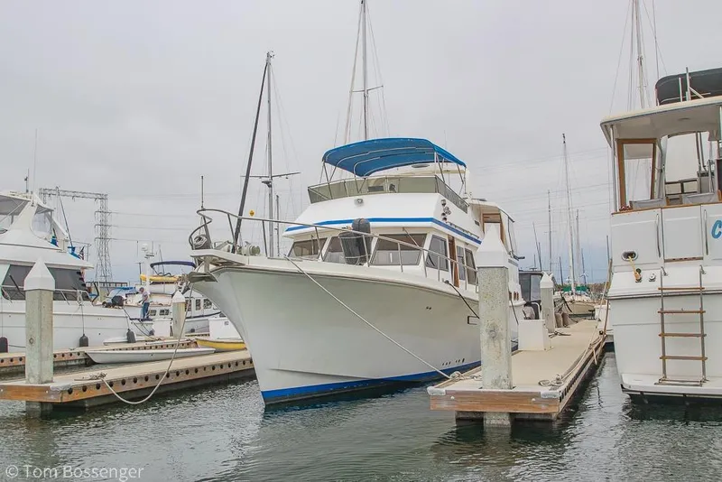 Slide: The Image of 1986 Ponderosa 47 yacht docked at marina, surrounded by other boats. - 92