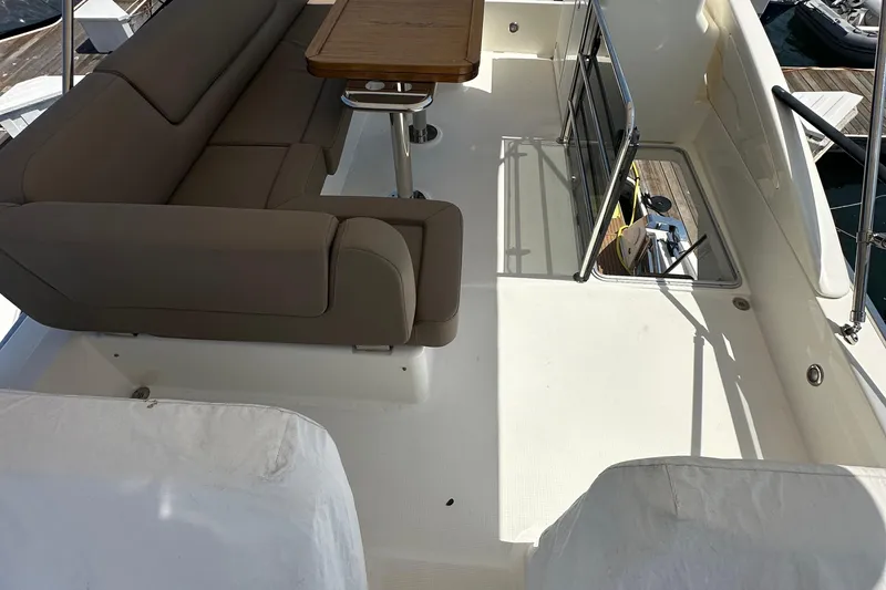 Slide: The Image of Flybridge seating area on 2017 Bavaria Virtess 420 Fly yacht with table and railing. - 12