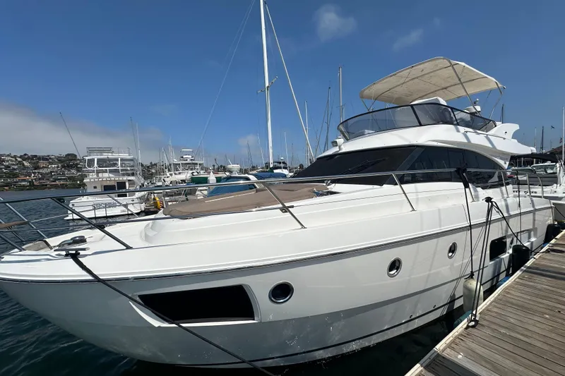 Slide: The Image of 2017 Bavaria Virtess 420 Fly yacht docked at marina under clear blue sky. - 2