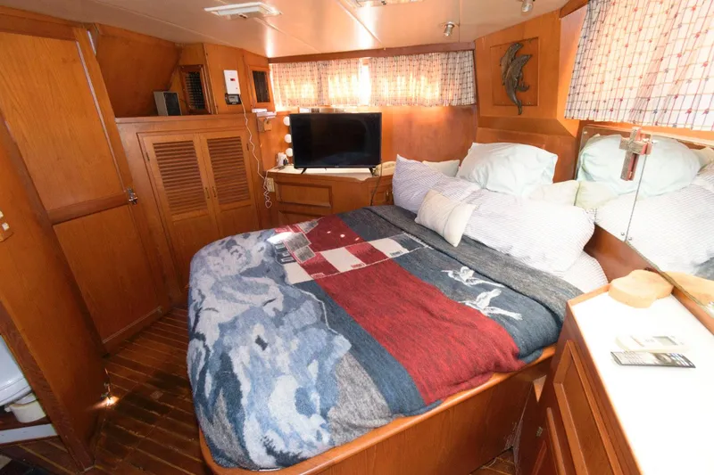 Slide: The Image of Cozy bedroom in 1988 Symbol 55 Cockpit Motor Yacht with TV and nautical decor. - 19