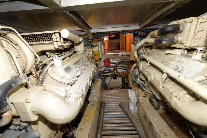 Slide: The Image of Engine room of 1988 Symbol 55 Cockpit Motor Yacht, showcasing dual engines and mechanical components. - 28
