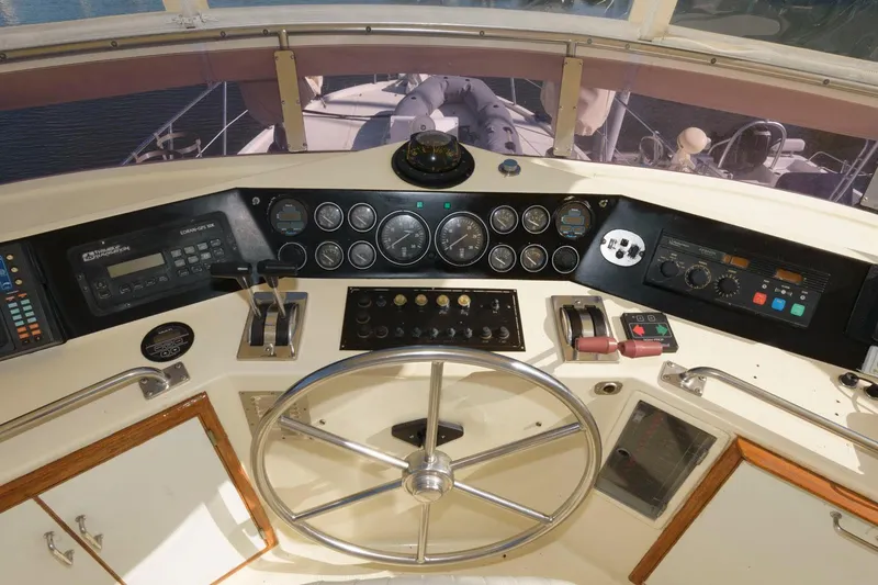 Slide: The Image of Cockpit of 1988 Symbol 55 Motor Yacht with steering wheel and control panels. - 9