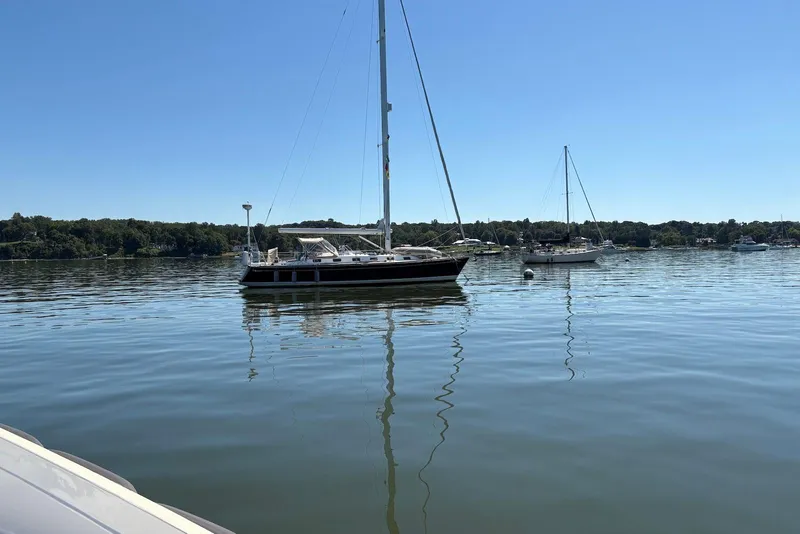 The Image of Sailboats on calm water, featuring a 2005 Tartan 4100 under clear blue skies. - 0