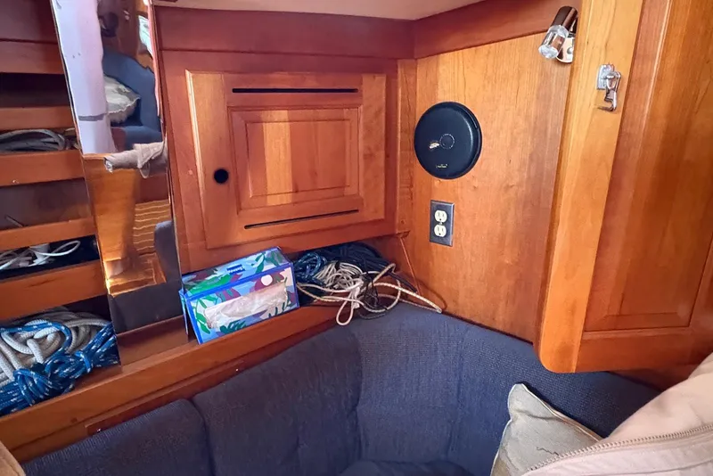 Slide: The Image of Cozy interior of 2005 Tartan 4100 sailboat with wooden cabinetry and seating area. - 11