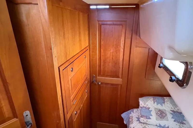 Slide: The Image of Wooden interior of 2005 Tartan 4100 sailboat cabin with bed and window. - 16